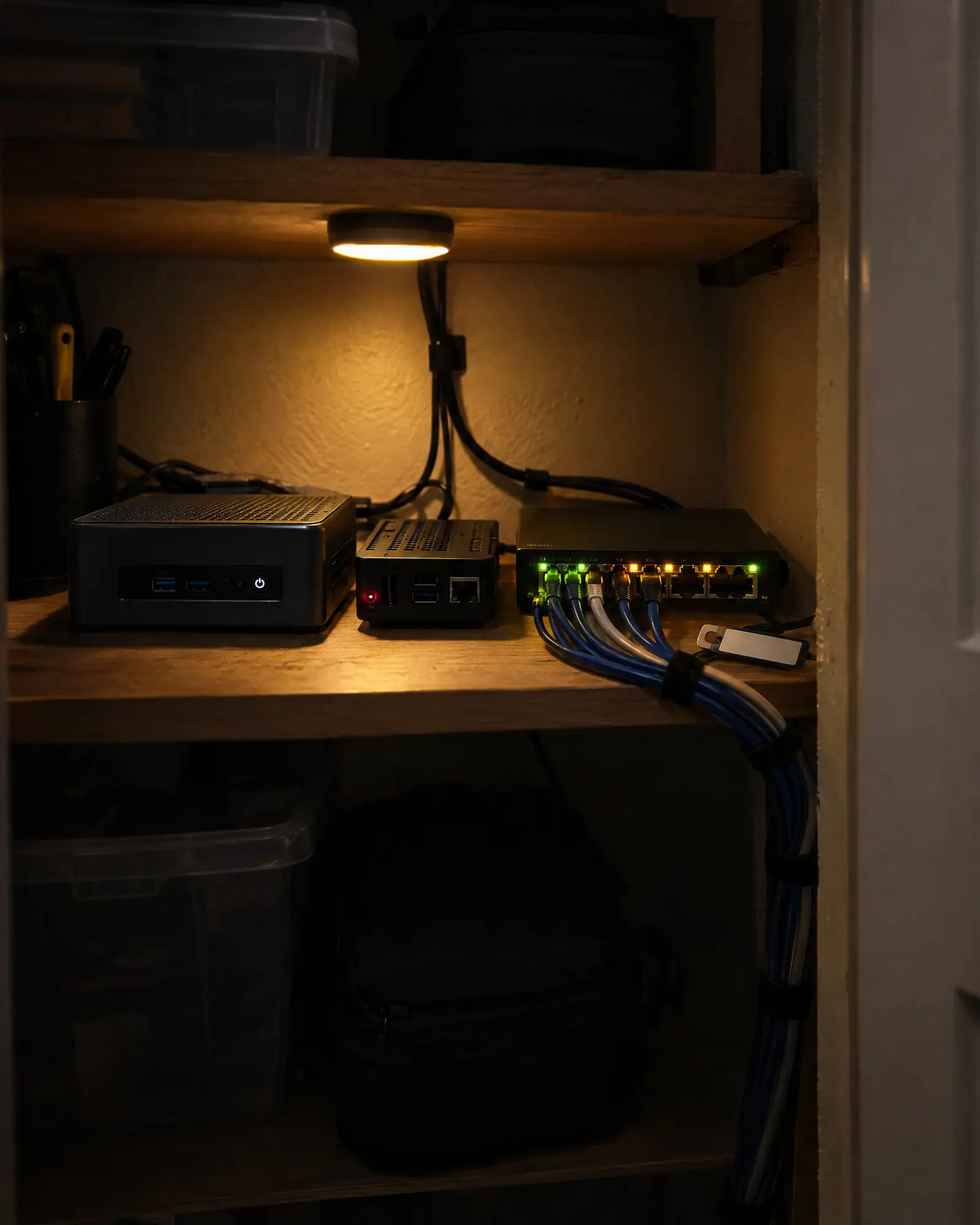 A home lab shelf with a mini PC, a Raspberry Pi and a network switch